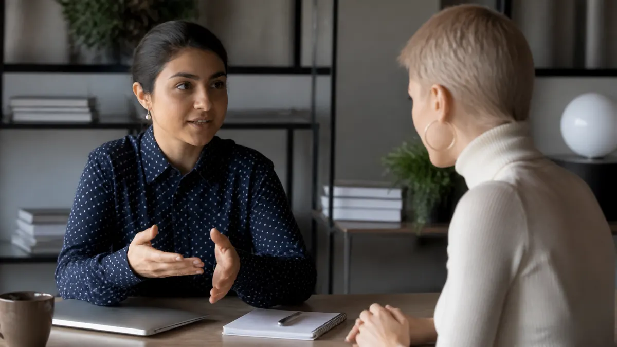 Photographic scene of a professional setting clear, compassionate work boundaries with a colleague, such as calmly explaining availability hours while maintaining a supportive